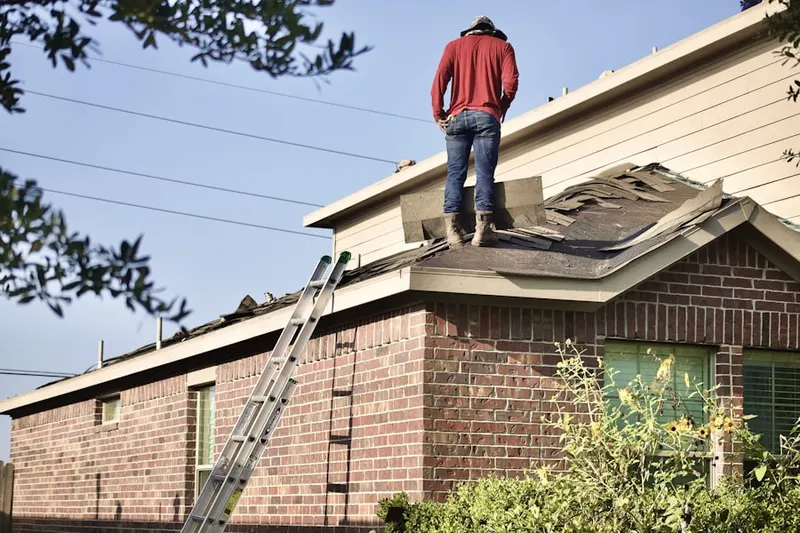 Professional roofer working on a residential roof in Groveland